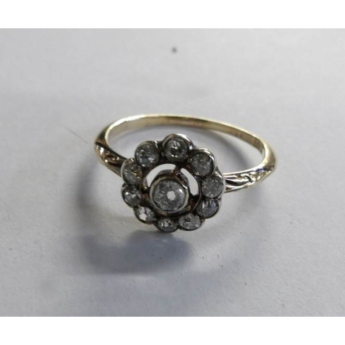 513 - An Edwardian old cut diamond cluster ring fashioned as a daisy in 18ct gold, size M half.