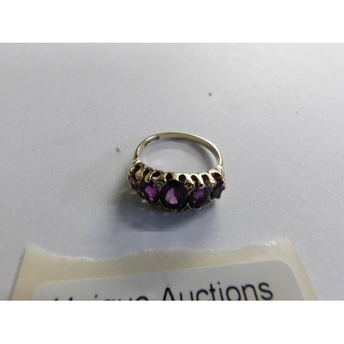 515 - A mid 20th century five stone amethyst set ring in 9ct gold, size M.