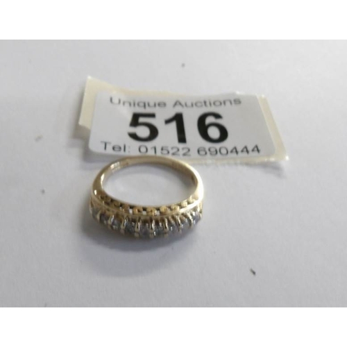 516 - A white stone set band ring in 14ct gold, size L.