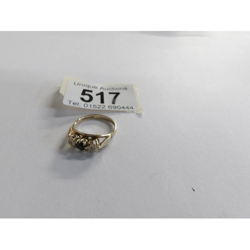 517 - A diamond and sapphire three stone ring in 9ct gold, size L half.