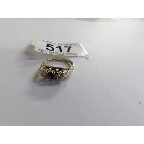 517 - A diamond and sapphire three stone ring in 9ct gold, size L half.