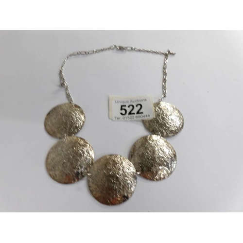 522 - A textured solid silver necklace as round discs.