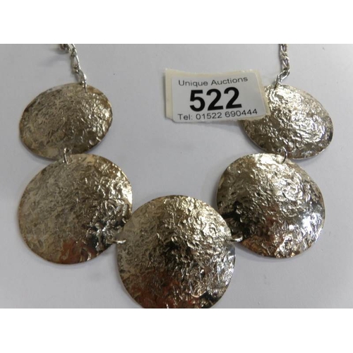 522 - A textured solid silver necklace as round discs.