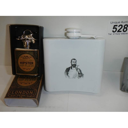 528 - 4 advertising hip flasks.