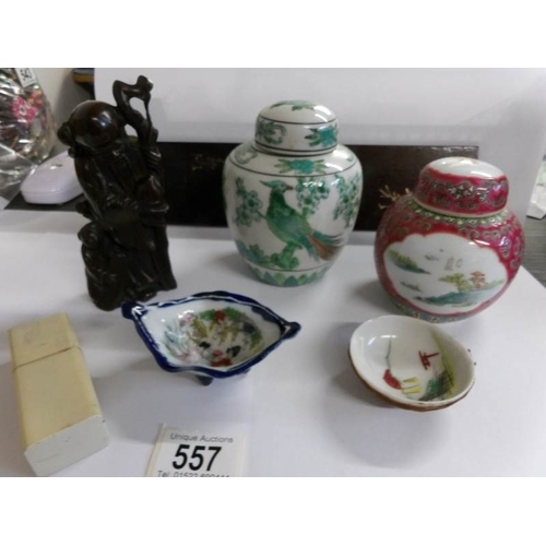 557 - A collection of Japanese and oriental ceramics, a wooden panel, sage figure etc, 7 items in total.