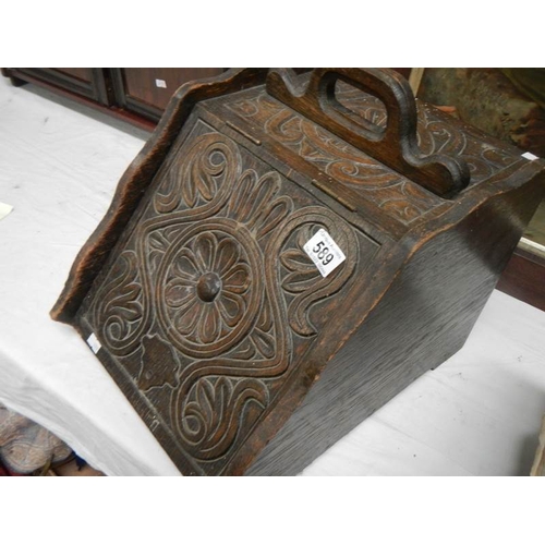 589 - A 1920's ornately carved coal box with liner.