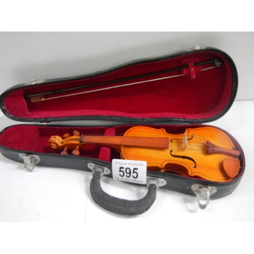 595 - A small cased violin with bow, 9'' long.