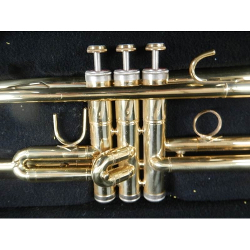 604 - An un-named brass trumpet in good working order and complete.