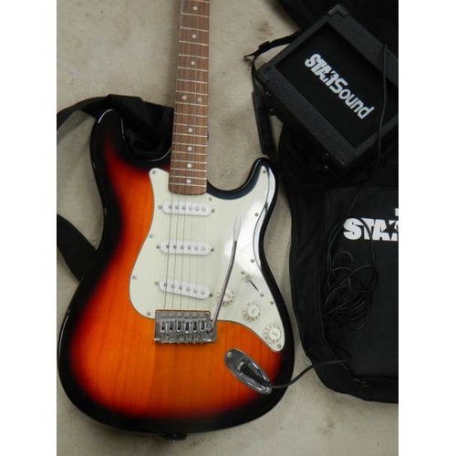 607 - A Starsound guitar with small amp.