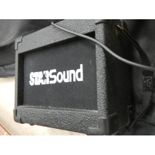 607 - A Starsound guitar with small amp.