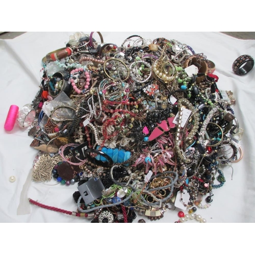 613 - A very large collection of unsorted costume jewellery,  (crate not included)