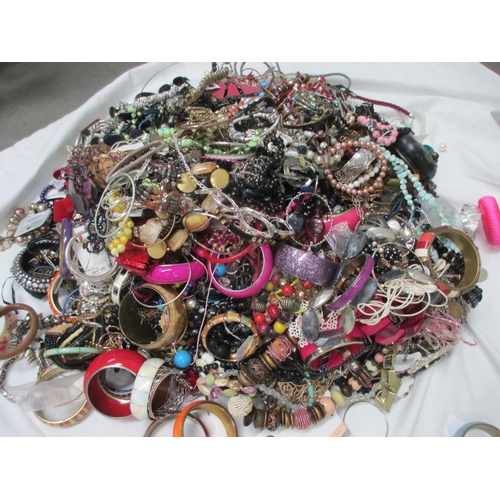 613 - A very large collection of unsorted costume jewellery,  (crate not included)