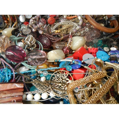 613 - A very large collection of unsorted costume jewellery,  (crate not included)