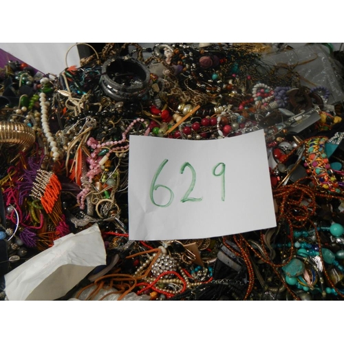 629 - A very large collection of unsorted costume jewellery (crate not included)