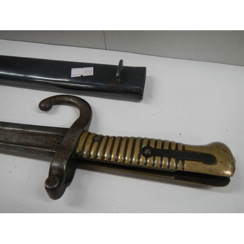 664 - A long French bayonet in original scabbard (70 cm / 27.5'' long).