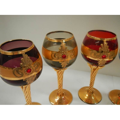 699 - A set of 6 Bohemian coloured glasses with gilding (in good condition).