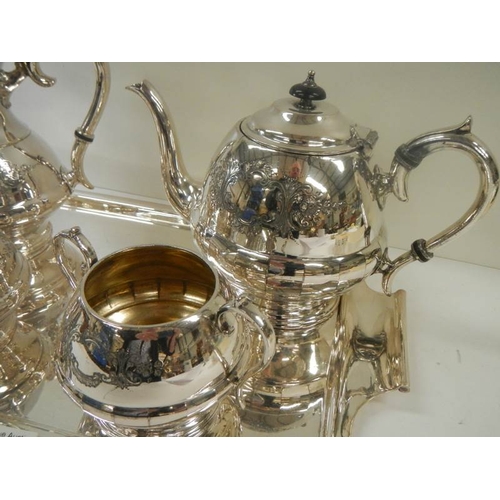 711 - A good quality silver plate 4 piece tea set on a silver plate tray.