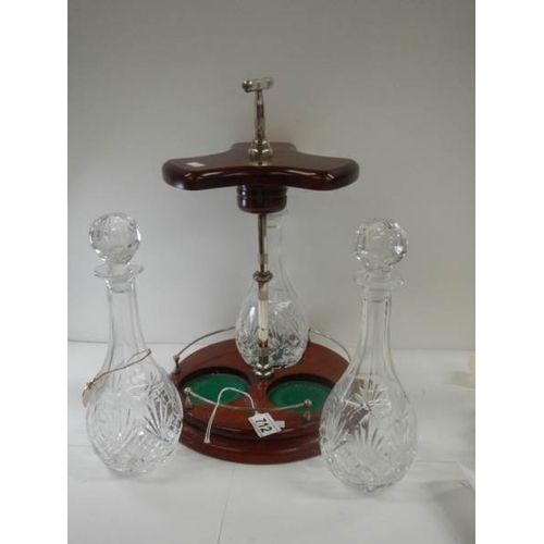 712 - A good quality 3 bottle tantalus on plated stand.