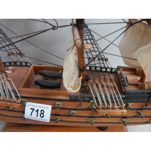 718 - A model sailing ship and a model Man o' war ship.