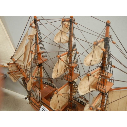 718 - A model sailing ship and a model Man o' war ship.