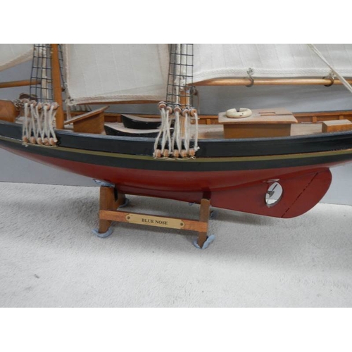 718 - A model sailing ship and a model Man o' war ship.