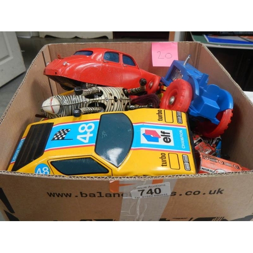 740 - A box containing tin and plastic toys.