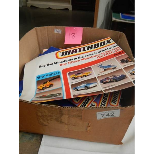 742 - A box of 1983 and 1986 Matchbox toy catalogues and some product posters.