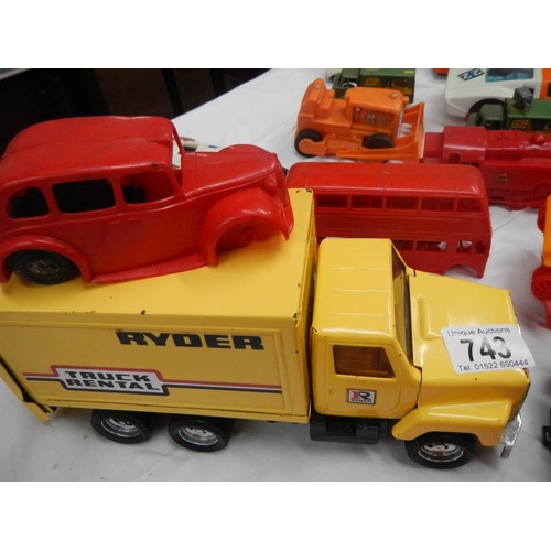 743 - A box of plastic and metal toy vehicles.