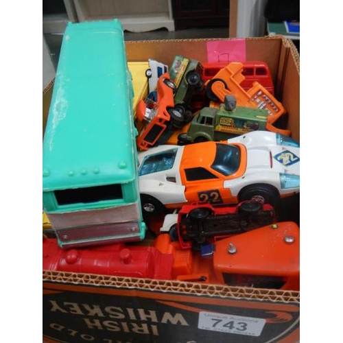 743 - A box of plastic and metal toy vehicles.