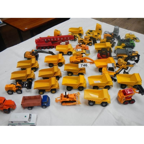 746 - A box containing various die cast dumper truck and truck models.