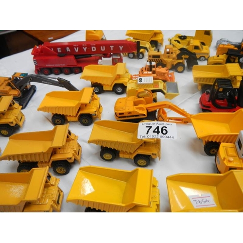 746 - A box containing various die cast dumper truck and truck models.