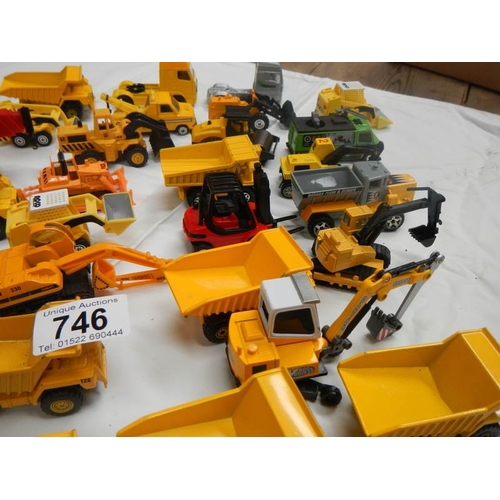 746 - A box containing various die cast dumper truck and truck models.