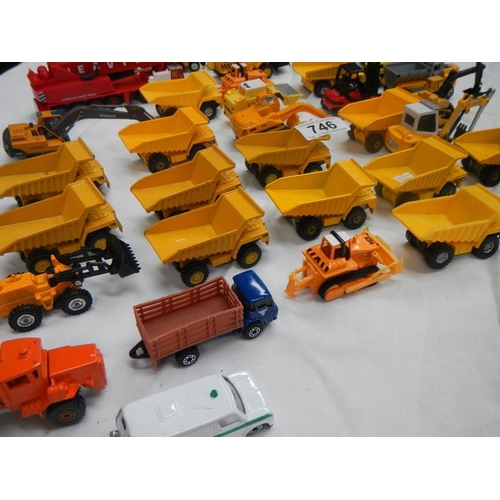 746 - A box containing various die cast dumper truck and truck models.