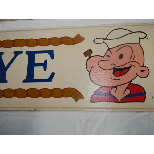 748 - Two 28'' x 7.5'' hand painted wooden Popeye and Olive Oil wall signs.