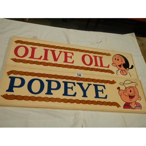 748 - Two 28'' x 7.5'' hand painted wooden Popeye and Olive Oil wall signs.