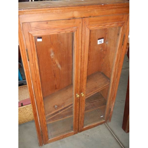 752 - A Pine wall cabinet with glass door.