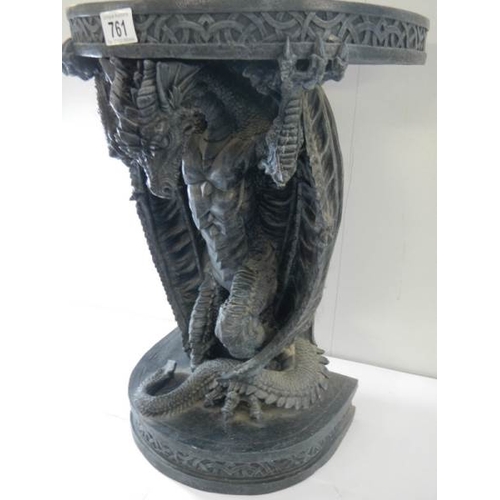 761 - A small late 20th century resin table with dragon base, 20'' high.