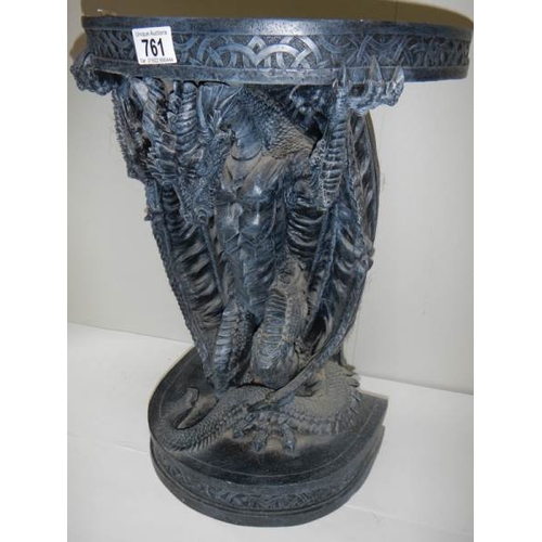 761 - A small late 20th century resin table with dragon base, 20'' high.