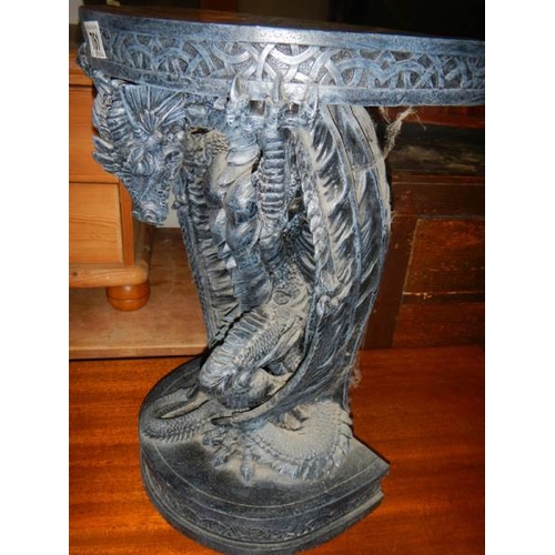 761 - A small late 20th century resin table with dragon base, 20'' high.