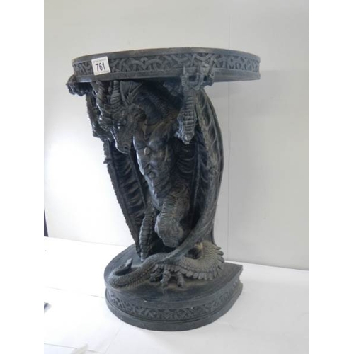 761 - A small late 20th century resin table with dragon base, 20'' high.