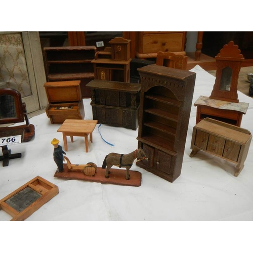 766 - A mixed lot of dolls house furniture.