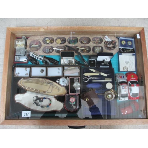 637 - A display case containing assorted jewellery, watches, model cars etc., (this lot is buyer collect o... 