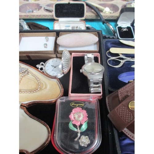 637 - A display case containing assorted jewellery, watches, model cars etc., (this lot is buyer collect o... 