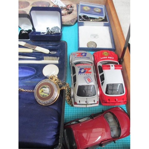 637 - A display case containing assorted jewellery, watches, model cars etc., (this lot is buyer collect o... 