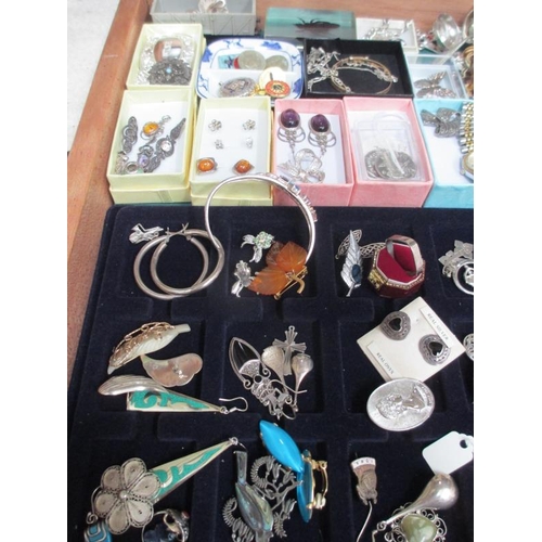 638 - A display case containing in excess of 100 pieces of mainly silver jewellery including earrings, pen... 