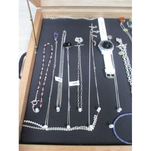 642 - A display case of mainly silver pendants, bracelets and chains, (this lot is buyer collect only).