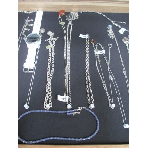 642 - A display case of mainly silver pendants, bracelets and chains, (this lot is buyer collect only).