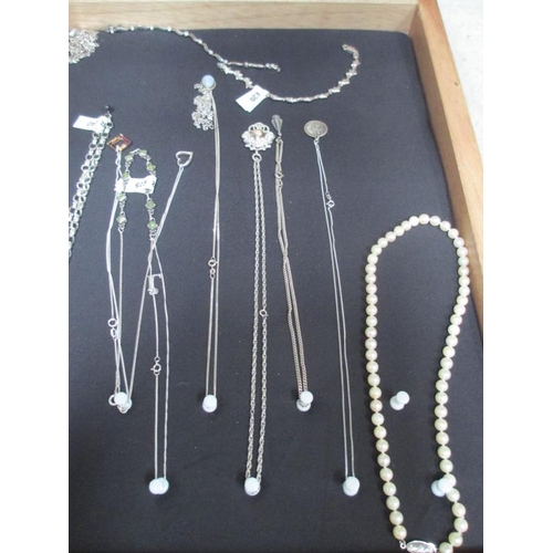 642 - A display case of mainly silver pendants, bracelets and chains, (this lot is buyer collect only).