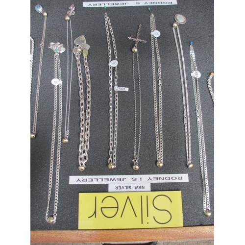 643 - A display case of mainly silver pendants, chains etc., (this lot is buyer collect only).