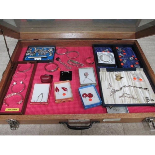 644 - A display case of silver bangles, charms, earrings etc., (this lot is buyer collect only).